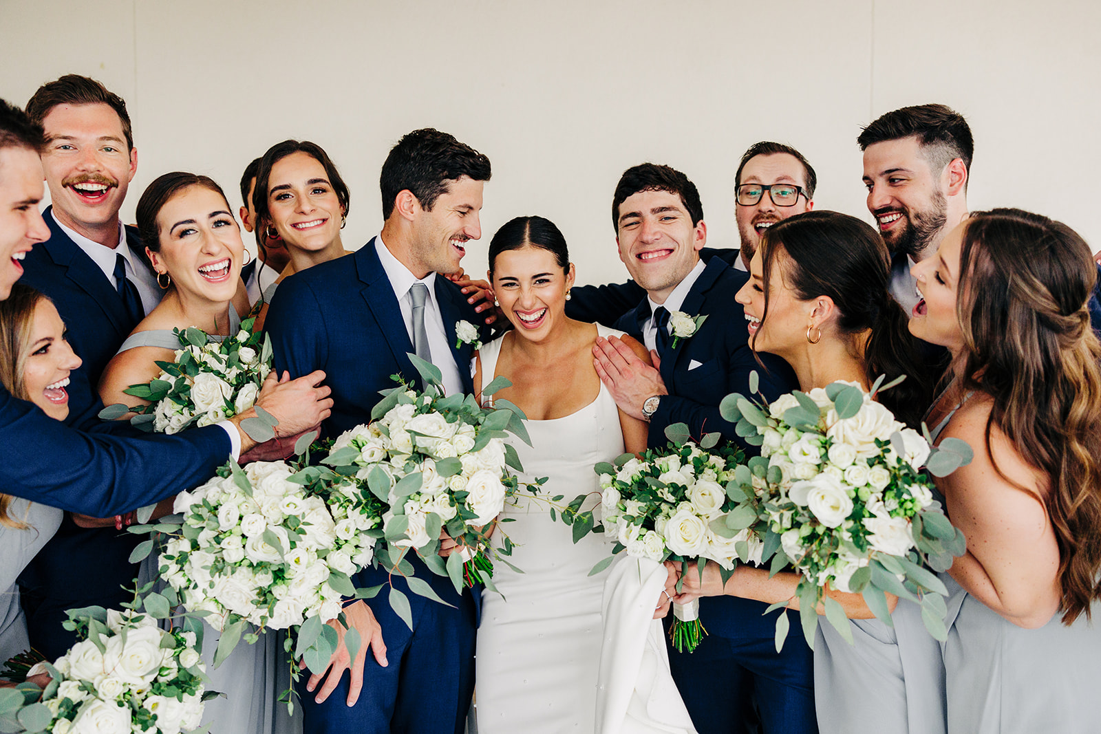 A bride and groom with their bridal party after the ceremony.